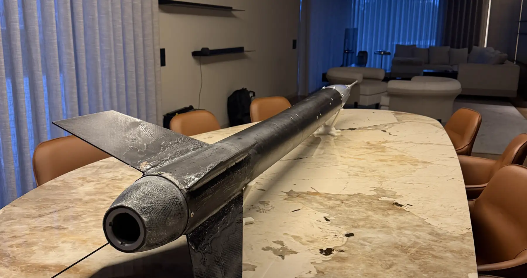 The aft end of Lynxrocket V5: the open motor tube mouth, the carbon fibre fin can and the body tube running away from the camera